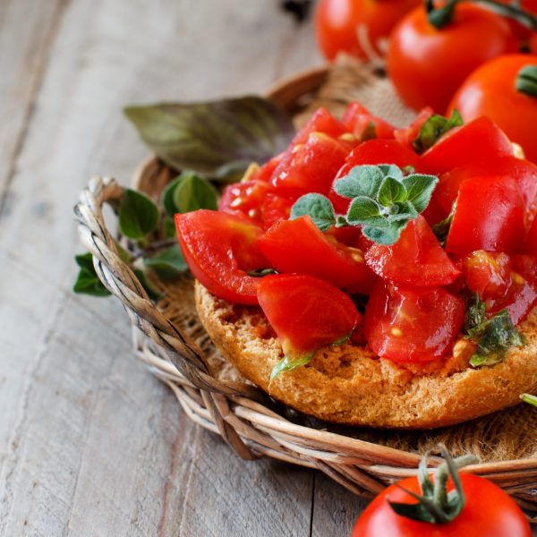 Frisella, typical south italian bread seasond with tomatoes and herbs